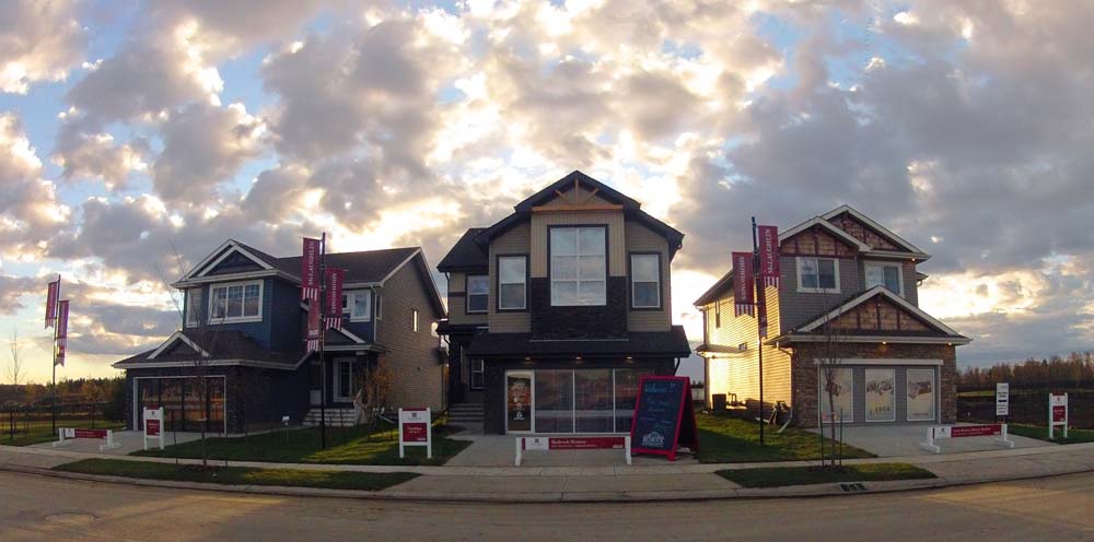 These Rosenthal showhomes are glowing in the light of the sunset. A flurry of clouds overhead, these high quality new builds in West Edmonton are new homes available for sale.